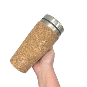 Hand Holding a Reusable Thermal Cork Cup  with a Lid - 450ml